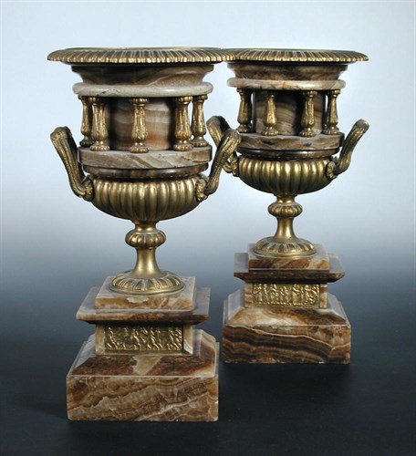 Lot 716 - A pair of late 19th / early 20th century  gilt metal mounted brown sinter urns