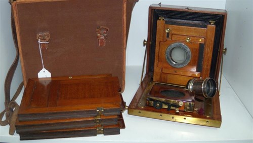 Lot 669 - An Edwardian brass bound mahogany quarter plate camera