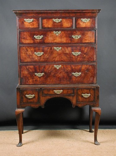 Lot 817 - An 18th century walnut chest on later stand