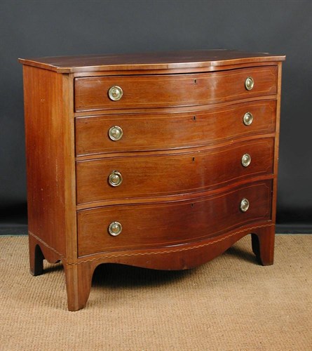 Lot 916 - A 19th century serpentine mahogany chest of drawers
