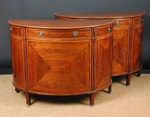Lot 890 - A pair of mahogany demi-lune commodes in the manner of Sheraton, 19th century