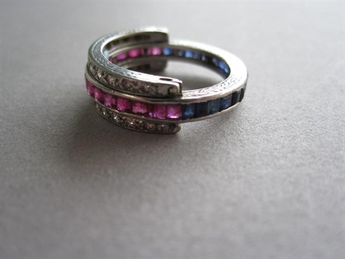 Lot 239 - A diamond ruby and sapphire swivel shank eternity ring