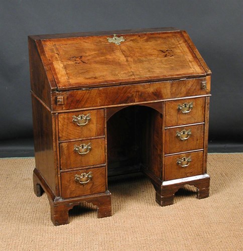 Lot 800 - An early 18th century walnut kneehole bureau, circa 1710