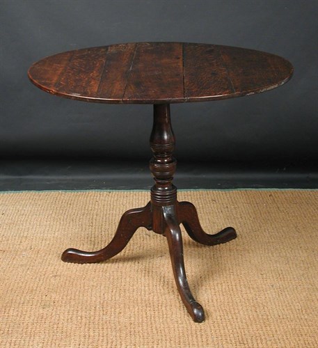 Lot 802 - A George III oak oval tripod tea table, circa 1790