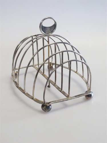 Lot 303 - A George IV silver wire framed toast rack