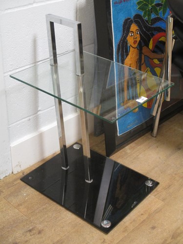Lot 399 - After Eileen Gray, a chrome and glass occasional table