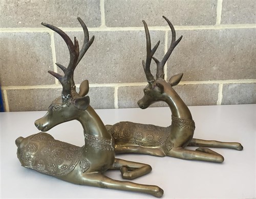 Lot 116 - A pair of decorative brass recumbent stags