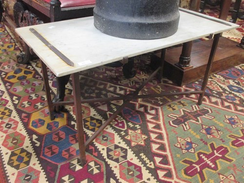 Lot 607A - A pair of marble and ironwork terrace tables in the style of Gilbert Poillerat, 42 x 80 x 40cm. (2)