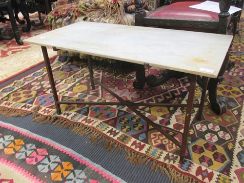 Lot 607 - A pair of marble and ironwork terrace tables in the style of Gilbert Poillerat, 42 x 80 x 40cm. (2)