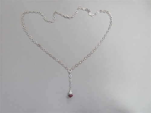 Lot 422 - An 18ct white gold and diamond set chain with a ruby and diamond pendant