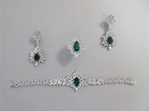 Lot 368 - A diamond and synthetic emerald suite of ring, earrings and bracelet