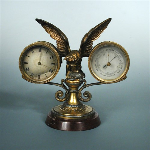 Lot 279 - A gilt spelter mounted desk timepiece and aneroid barometer
