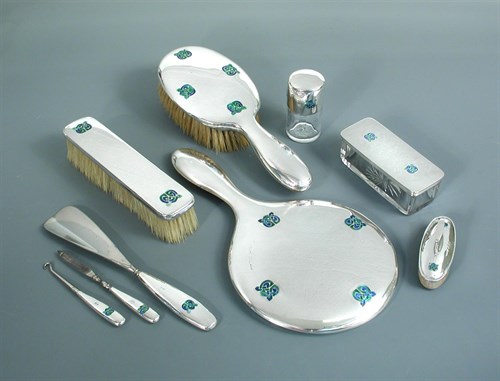 Lot 107 - Liberty & Co., a silver and enamel dressing table set