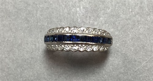 Lot 252 - A sapphire and diamond three row half hoop ring set in 18ct white gold