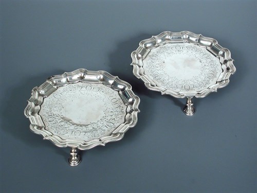 Lot 33 - A pair of George II circular silver waiters by Samuel Courtauld