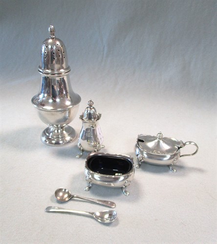Lot 61 - A 20th century silver three piece condiment set and a silver sugar caster