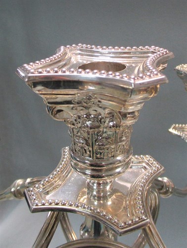 Lot 74 - A pair of George V silver four branch five light candelabra