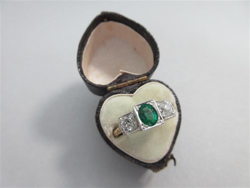 Lot 374 - An Art Déco style emerald and diamond three stone ring