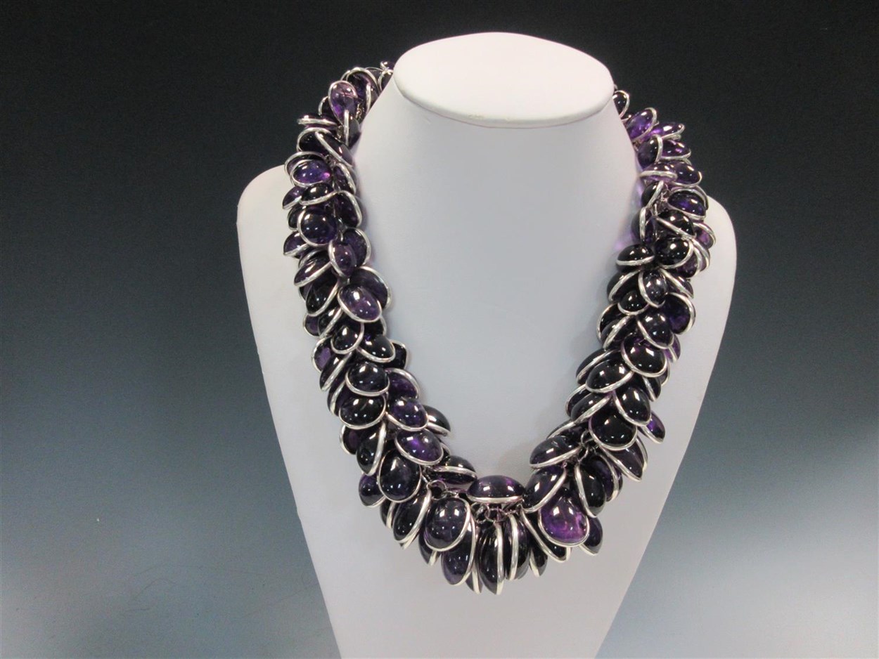 Lot 415 - A contemporary amethyst and silver statement necklace