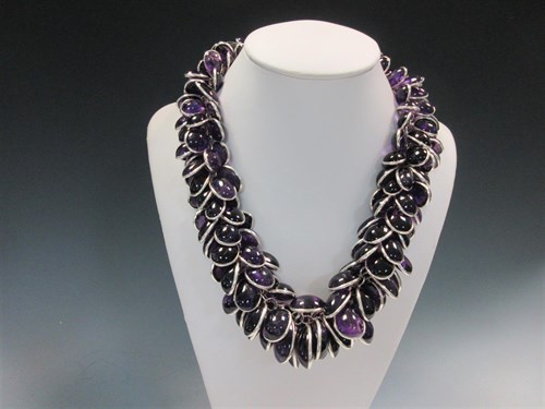 Lot 415 - A contemporary amethyst and silver statement necklace