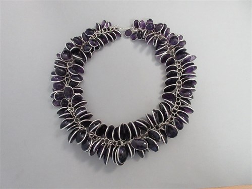 Lot 415 - A contemporary amethyst and silver statement necklace