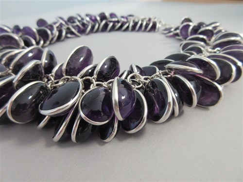 Lot 415 - A contemporary amethyst and silver statement necklace