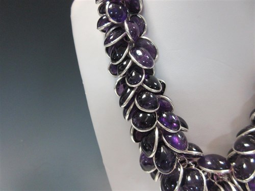 Lot 415 - A contemporary amethyst and silver statement necklace