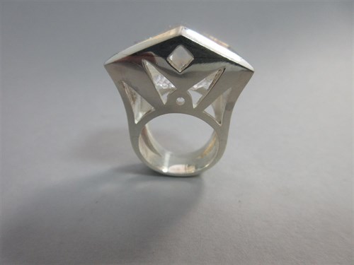 Lot 239 - A futuristic rock crystal 'knuckle duster' ring