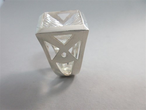 Lot 239 - A futuristic rock crystal 'knuckle duster' ring