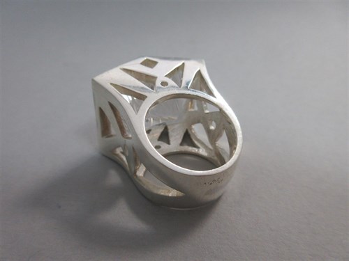 Lot 239 - A futuristic rock crystal 'knuckle duster' ring