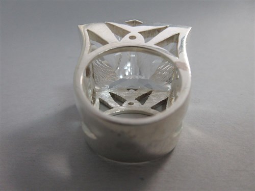 Lot 239 - A futuristic rock crystal 'knuckle duster' ring