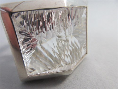 Lot 239 - A futuristic rock crystal 'knuckle duster' ring