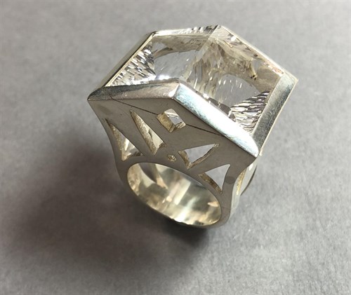 Lot 239 - A futuristic rock crystal 'knuckle duster' ring