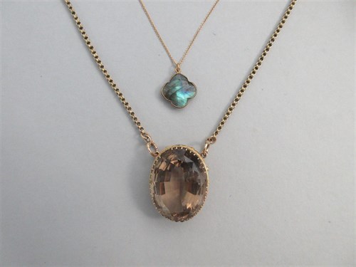 Lot 197 - A large smoky quartz pendant with chain together with a quatrefoil labradorite pendant and chain