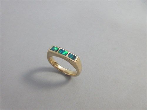 Lot 362 - A three stone black opal ring set in 18ct gold