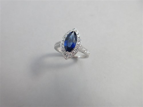 Lot 274 - A marquise cut sapphire and diamond cluster ring set in 18ct white gold