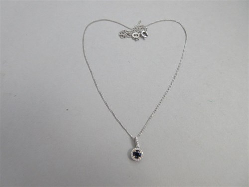 Lot 273 - A sapphire and diamond cluster pendant and chain