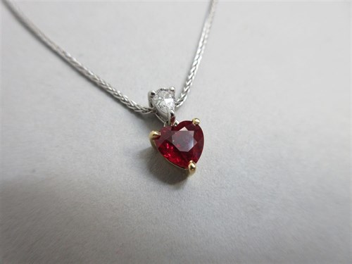 Lot 444 - A ruby and diamond heart pendant with integral chain of 18ct white gold