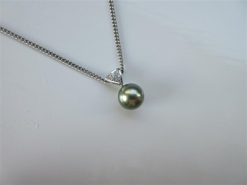Lot 378 - A 'pistachio' yellow-green Tahitian cultured pearl and diamond pendant on chain