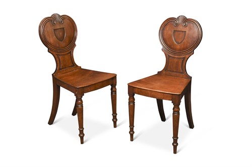 Lot 406 - A pair of Regency mahogany hall chairs, with...