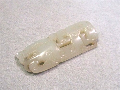Lot 299 - A Chinese jade applique and a jade belt hook, 18th and 20th century