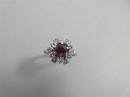 Lot 428 - A ruby and diamond cluster ring set in 18ct white gold