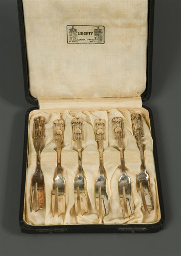 Lot 114 - Liberty & Co., a cased set of six silver cake forks