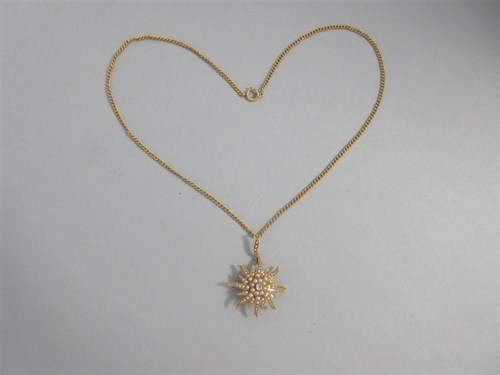 Lot 328 - An antique diamond and seed pearl sunburst pendant / brooch with chain