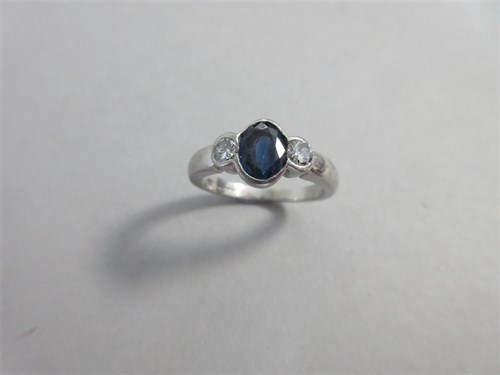 Lot 282 - A contemporary sapphire and diamond three stone ring set in platinum