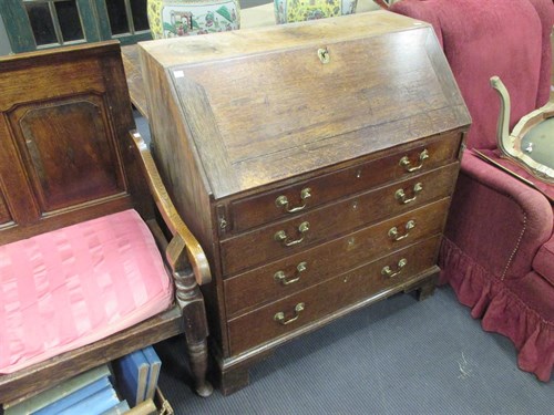 Lot 387 - A George III oak bureau of classic design,...