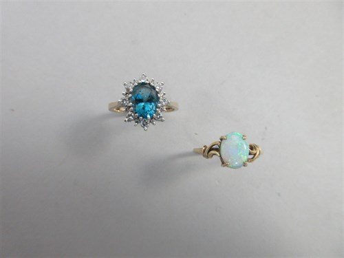 Lot 355 - A blue topaz and diamond cluster ring together with an opal, single stone ring