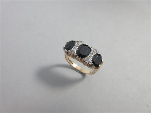 Lot 241 - A sapphire and diamond ring set in hallmarked gold