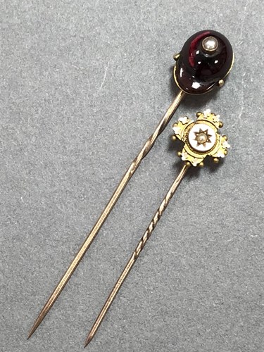 Lot 447 - A garnet and seed pearl jockey's cap stick pin and a Victorian gold and seed pearl stick pin