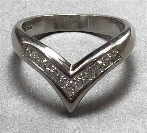 Lot 448 - A platinum and princess cut diamond wishbone ring